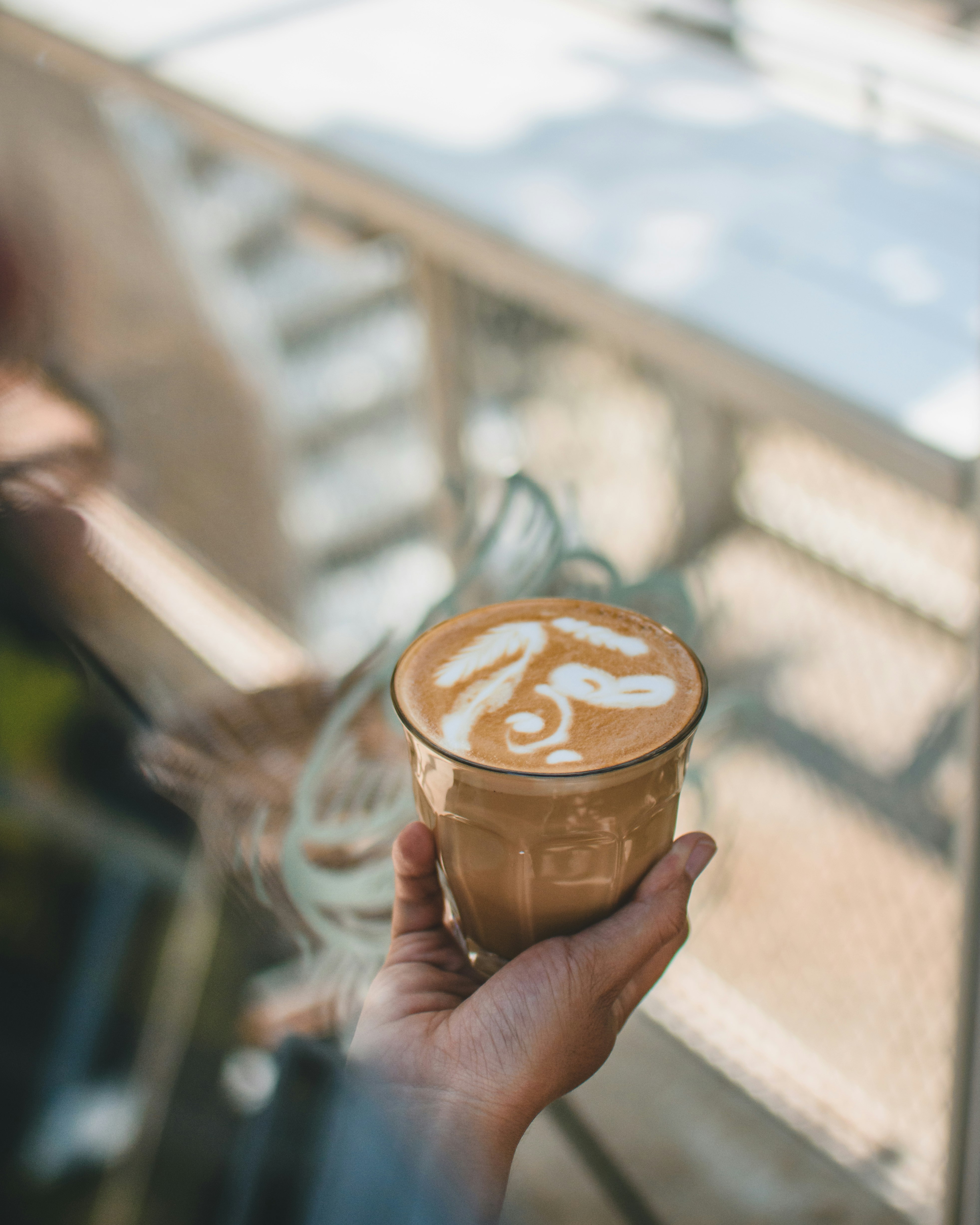 person holding glass of coffee